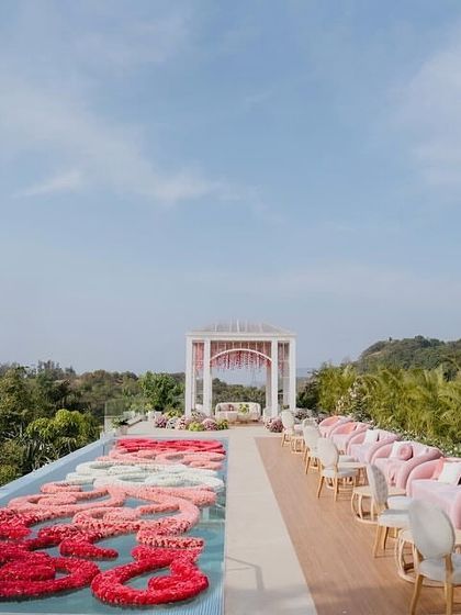 The serene setting for the Lagan Lakhwanu ceremony, with a floral rangoli in the pool and a minimalist mandap overlooking the lush landscape. The design was modern, spiritual, and deeply personal.