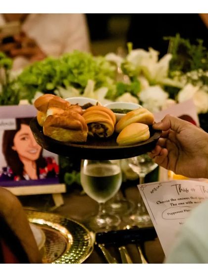 A guest is served an assortment of freshly baked breads and warm desserts at their table. We ensure our baked goods are served with the same care and attention as our main courses.