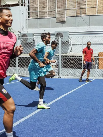 A coach observing a running drill with Sporting Club Bengaluru players. Every session is an opportunity to refine technique and push the limits of performance.