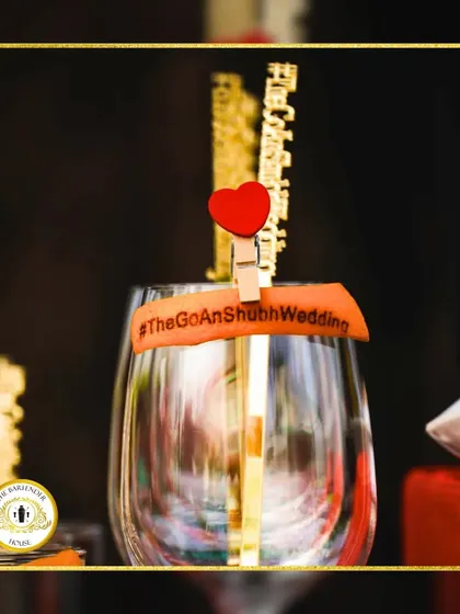 A custom drink band with the wedding hashtag, #TheGoAnShubhWedding, and a heart clip. These small details help tie the entire event theme together.