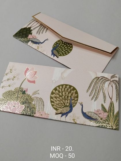 A light-colored envelope with subtle traditional arch motifs and lotus flowers in the corners. The design uses delicate gold foil work for a premium feel.