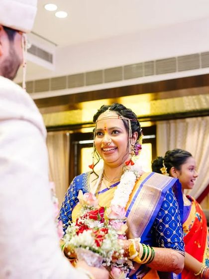 The groom's welcoming smile as he sees his bride during the ceremony, a moment filled with warmth and happiness.