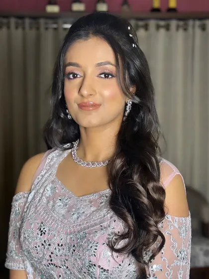 Pooja looking radiant and ready for her sangeet. The makeup is designed to enhance her natural beauty.