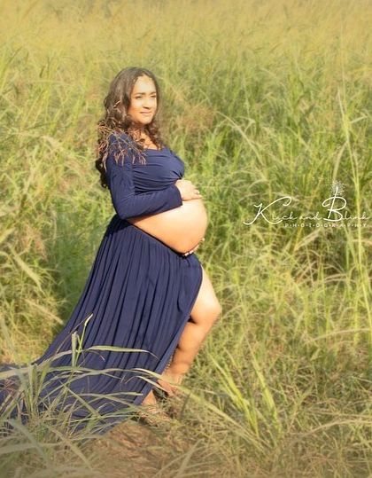 Finding a quiet moment of reflection amidst nature. This portrait, taken in a field of tall grass, feels so serene and highlights the peaceful connection between a mother and her unborn child.