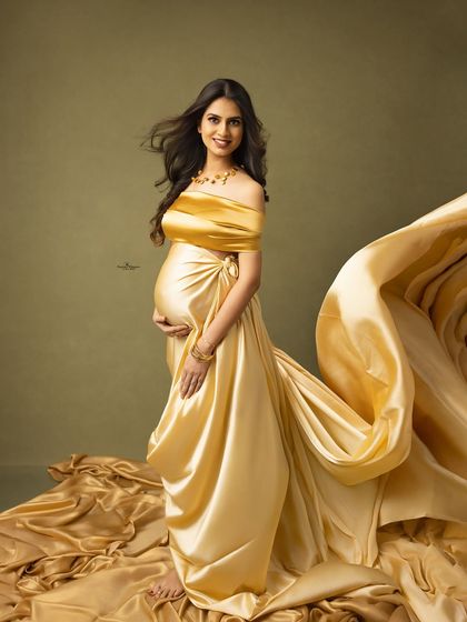 A dramatic flying fabric shot with a luxurious golden gown. The fabric creates a stunning wave of motion, resulting in a truly breathtaking portrait.