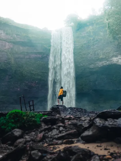 A self-portrait at the base of Phe Phe falls in Meghalaya, capturing the scale of the waterfall and the spirit of adventure.