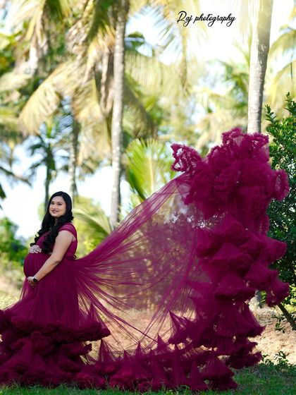 A dramatic flying gown shot with a wine-colored ruffled dress, creating a stunning visual in our outdoor location.