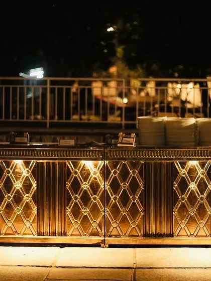 A sleek, modern buffet counter with elegant lighting. This setup is perfect for corporate events or contemporary wedding receptions where a sophisticated look is desired.