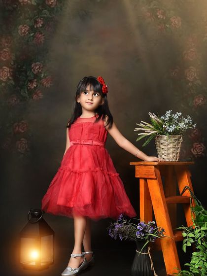 A classic portrait for a five-year-old. The simple, dark background and elegant red dress create a timeless and beautiful fine art image.