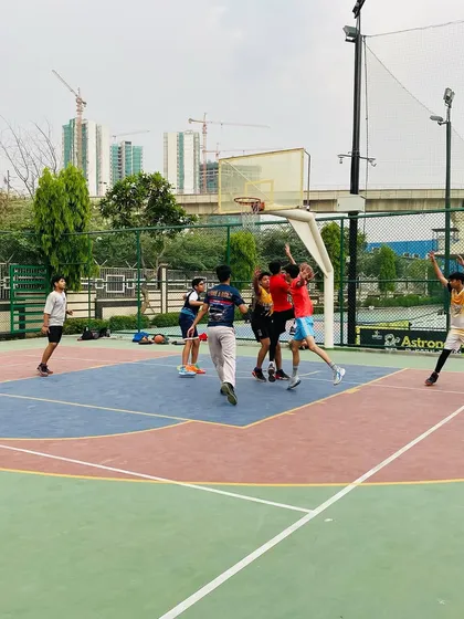 The intensity of a game is captured as players battle for the ball under the basket.