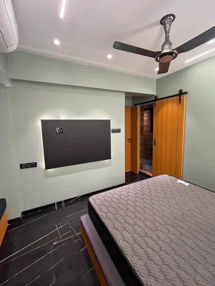 A look at a bedroom with a unique barn door and striking black marble flooring. I enjoy mixing textures and materials to give each room its own distinct personality while maintaining a modern aesthetic.