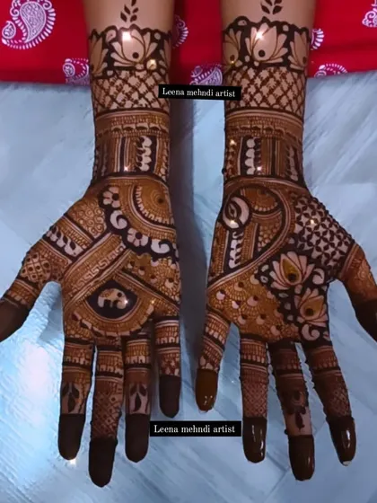 This design features a unique combination of an elephant motif in the palm with lotus flowers on the wrist. It's a great example of how I can mix different elements for a custom look.