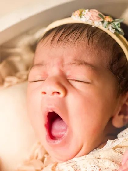 The tiniest yawn from the tiniest person. It's these fleeting, simple moments that hold so much beauty. Capturing details like this is at the heart of my newborn photography sessions.
