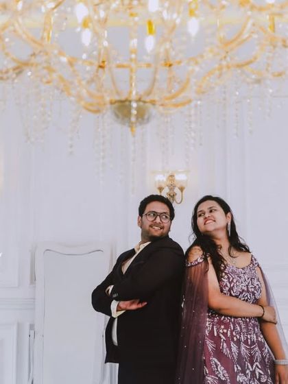 An all-white, classic European-style studio sets the stage for pure romance. The grand piano and crystal chandelier add a touch of musical elegance to this couple's pre-wedding photos.