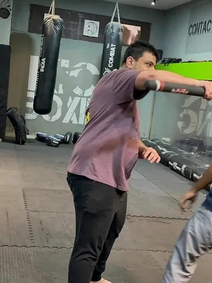 After blocking the stick, the next step is to counter-attack immediately. Here, I'm demonstrating a strike to the attacker's head while maintaining control of the weapon. You must be aggressive to shut down the threat.
