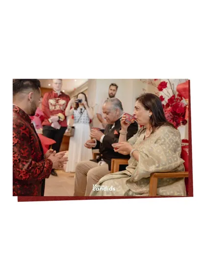 The tea ceremony continues, with the couple serving tea to the groom's parents. It’s a quiet moment of acceptance and the blending of two families.