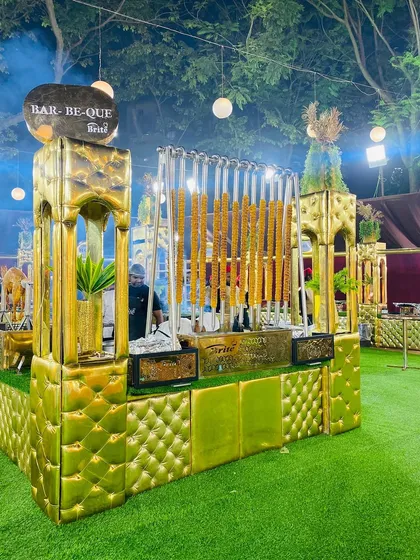 A corner view of the elaborate barbecue station, showcasing the unique design and impressive display of grilled meats.