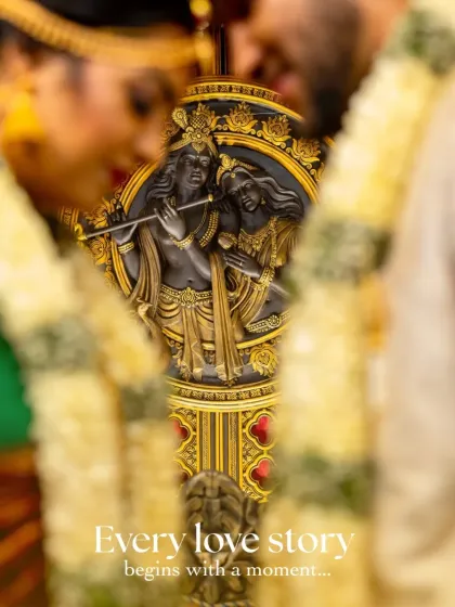 This is a detail shot focusing on a beautiful Radha Krishna idol, with the couple blurred in the foreground. It’s a creative way to symbolize the couple's union while honoring the cultural elements of the ceremony.