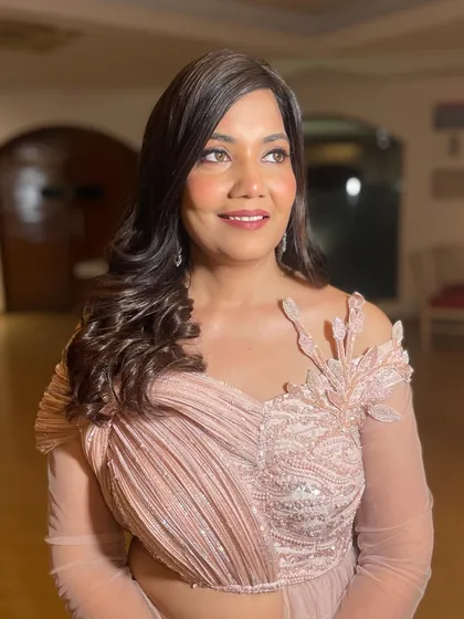 A romantic, voluminous hairstyle with a side part and big waves, perfect for a reception or cocktail gown.