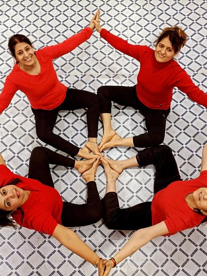 Another variation of the four-person Acro Yoga star, showing the versatility and creativity we explore in our partner and group sessions.