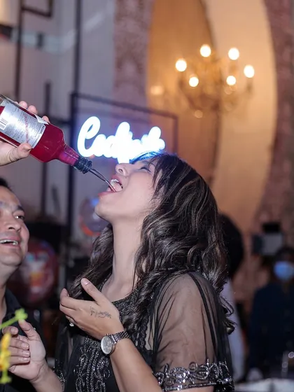 A guest enjoying a shot straight from the bottle, poured by one of my entertainers. I create a fun and relaxed atmosphere where everyone feels comfortable letting loose.