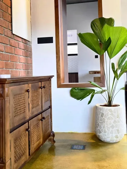 Another view of the terrazzo planter, showing how it perfectly holds a fan palm, adding a touch of tropical elegance to the room.