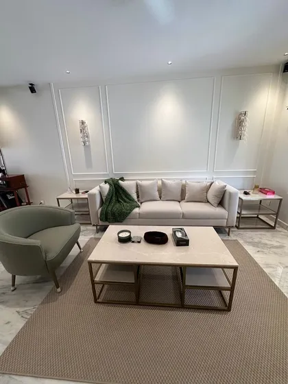 Another view of this elegant living room, highlighting the proportions of our custom sofa and the two-tiered marble and metal coffee table. Each piece is designed to complement the others and enhance the overall aesthetic of the home.