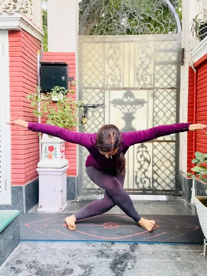 A revolved chair pose, Parivrtta Utkatasana, which detoxifies the body and builds leg strength. It's a reminder to stretch your body and mind, allowing good vibes to flow naturally.