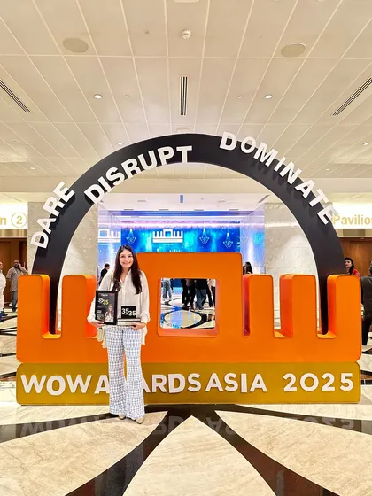 Celebrating the win at the WOW Awards Asia 2025. Standing under the 'Dare Disrupt Dominate' archway feels like a perfect summary of my entrepreneurial journey.