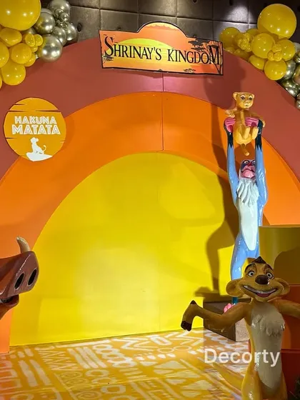 A close-up of the main stage, highlighting the iconic scene of Rafiki holding up Simba on Pride Rock.