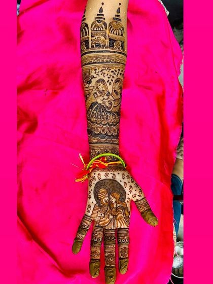 A close up of a single arm, showcasing a detailed portrait of a couple, a scene with two women, and architectural dome motifs, perfect for telling a rich story.