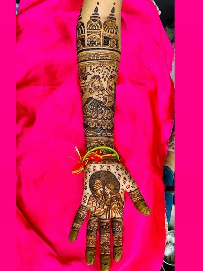 A close up of a single arm, showcasing a detailed portrait of a couple, a scene with two women, and architectural dome motifs, perfect for telling a rich story.