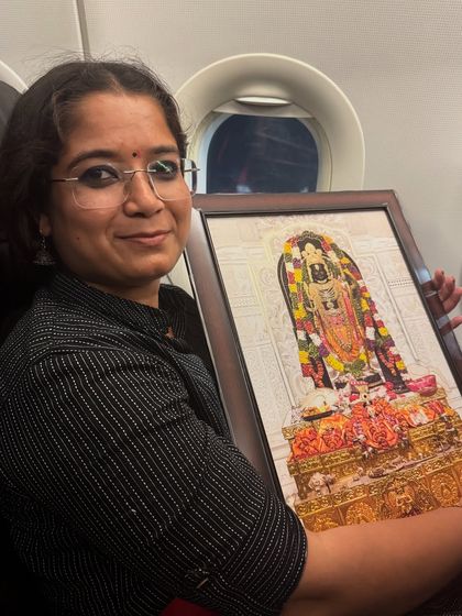 Holding the portrait of Ram Lala during my flight. This experience was a reminder of the divine grace that guides my path.