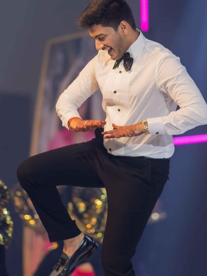 Another glimpse of our 'Hero No. 1' groom, completely owning the dance floor. His energy was infectious, and he nailed every single step of the choreography with a huge smile on his face.