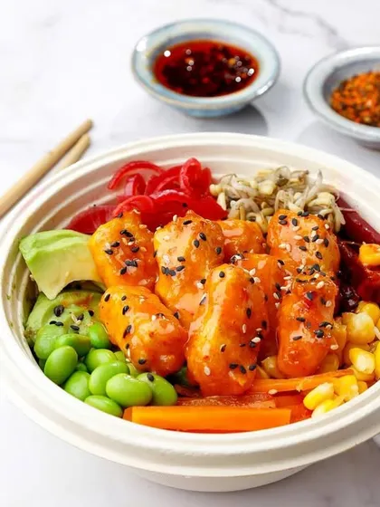 A vibrant and healthy poke bowl in a round takeaway container, showcasing all the colourful ingredients.