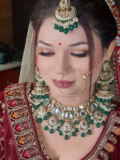 A very subtle and beautiful look for this bride in a maroon velvet lehenga. The makeup is soft and natural, letting her features shine.