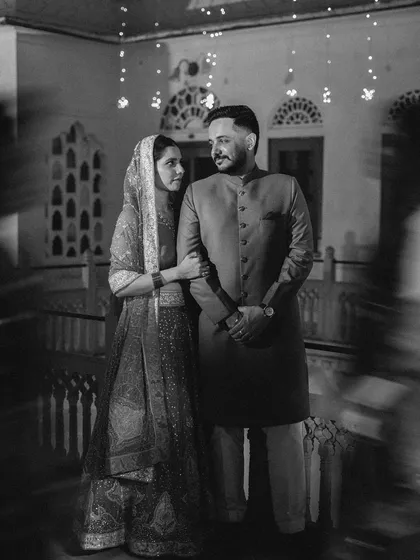 A timeless black and white portrait of a couple, with a slow shutter effect creating a dreamy, artistic motion blur.