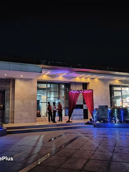 The entrance to the venue at night. I used simple red drapes and blue fairy lights on the bushes to guide guests and create a welcoming ambiance.