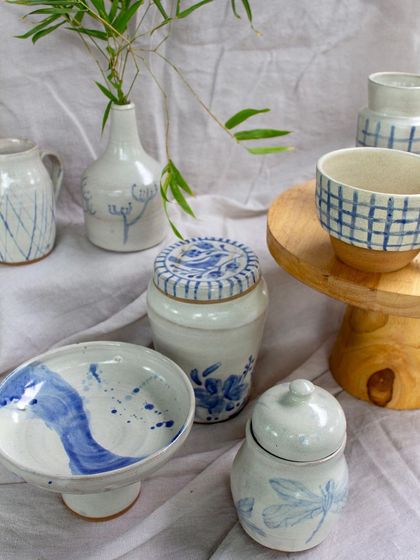 The same blue and white collection, highlighting the delicate hand-painted details and classic forms.
