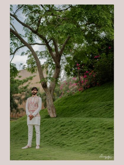 A solo portrait of the groom, looking thoughtful amidst the natural beauty of the location.