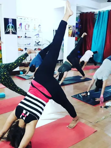 The dynamic energy of Eka Pada Adho Mukha Svanasana (Three-Legged Downward-Facing Dog). This variation of the classic pose opens the hips and builds upper body strength.
