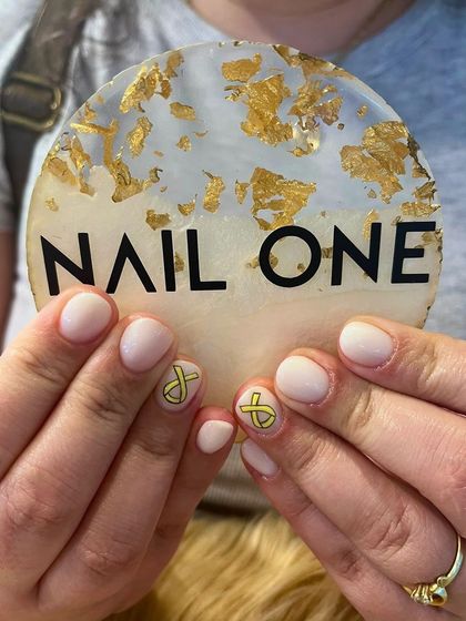 We also create nail art for important causes. This simple yet meaningful design features a yellow ribbon, symbolizing support and awareness, painted on a clean, short nail.