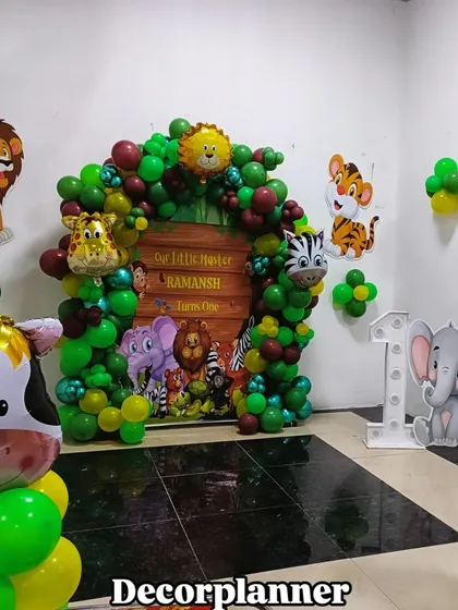 A full view of the compact jungle theme setup, perfect for home celebrations. It includes the main backdrop, marquee number, and additional animal cutouts and balloon columns to fill the space.