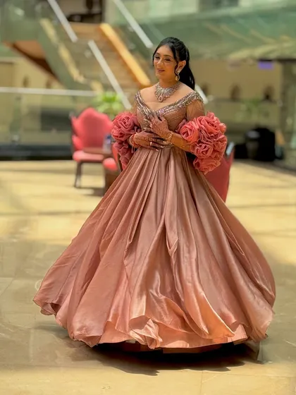 A full-length shot showing the magnificent flow of her pink gown.