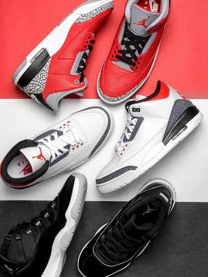 A flat lay of several pairs of classic Jordan sneakers, arranged neatly to showcase different colorways. This type of shot is great for displaying a collection or a range of product options.