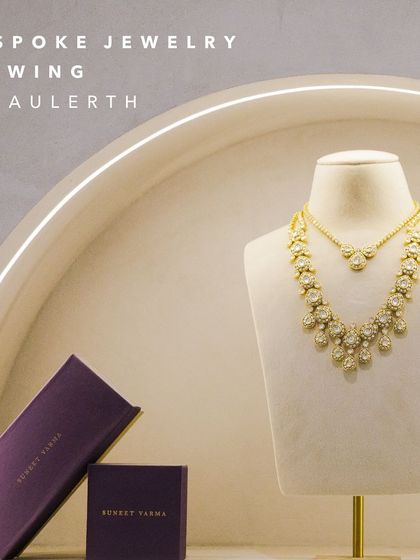 A bespoke jewelry viewing setup at our New Delhi store, featuring a layered necklace from the Suneet Varma collection. We create an elevated experience for every visitor.