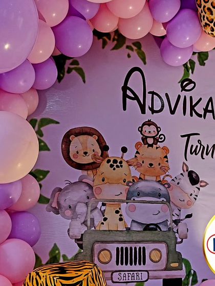 A close-up of a jungle-themed backdrop, featuring cute cartoon animals on a safari jeep.