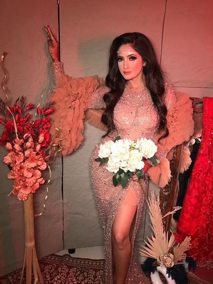 A full-length view of the 'Laila' look, showcasing the stunning silhouette of the gown and the soft, romantic makeup.