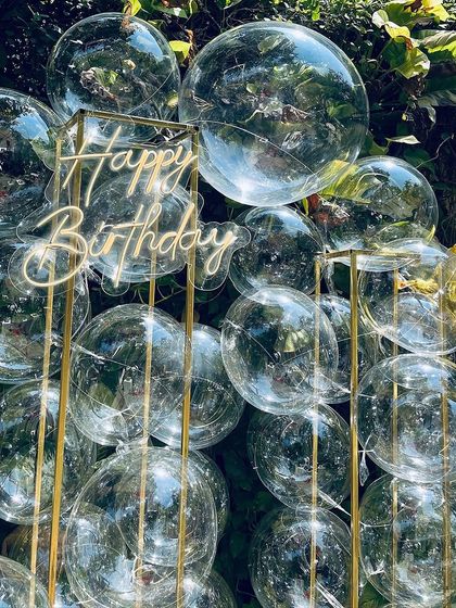 A close-up of the bubble backdrop with the 'Happy Birthday' sign, showing how the transparent spheres create a light and airy feel.