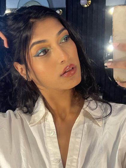 Eyes so fresh, they're evergreen. A selfie showing off a creative green graphic liner, proving that inspiration can strike anywhere, anytime.